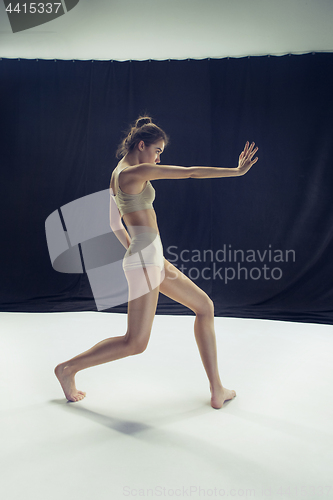 Image of Young teen dancer ion white floor background.