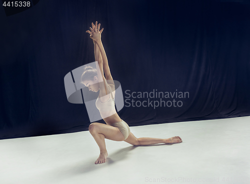 Image of Young teen dancer ion white floor background.