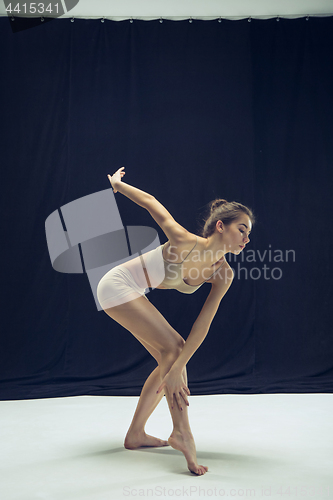 Image of Young teen dancer ion white floor background.