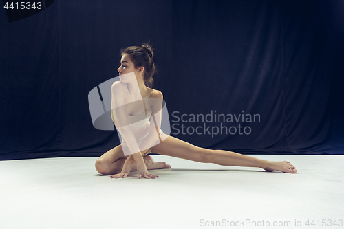 Image of Young teen dancer ion white floor background.