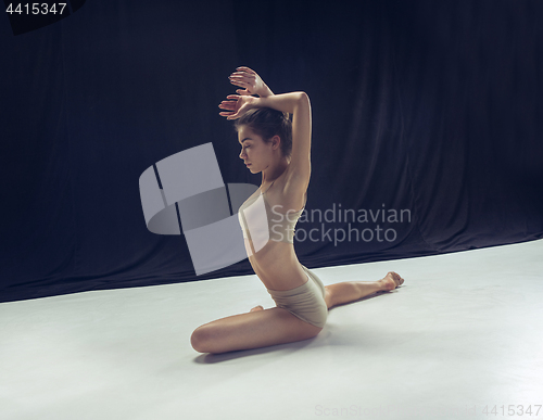 Image of Young teen dancer ion white floor background.