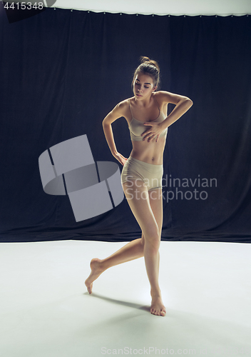 Image of Young teen dancer ion white floor background.