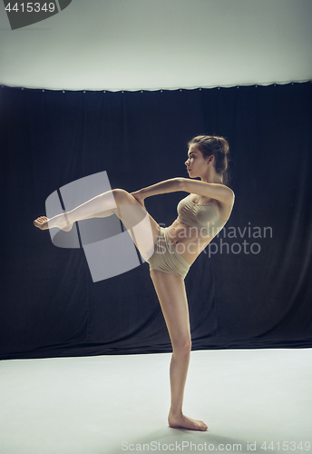 Image of Young teen dancer ion white floor background.