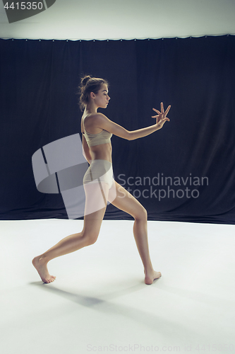 Image of Young teen dancer ion white floor background.