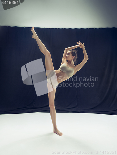 Image of Young teen dancer ion white floor background.