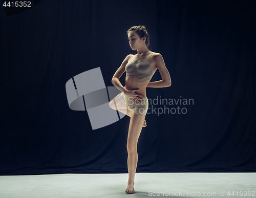 Image of Young teen dancer ion white floor background.