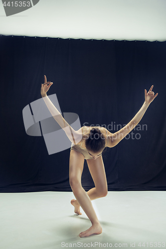 Image of Young teen dancer ion white floor background.