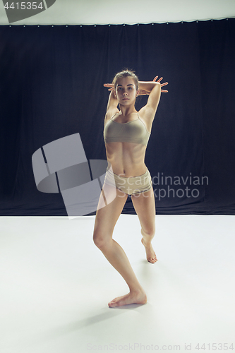 Image of Young teen dancer ion white floor background.