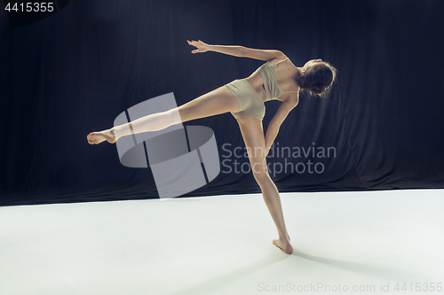 Image of Young teen dancer ion white floor background.