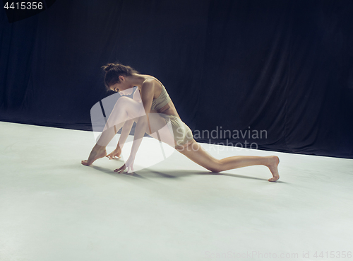 Image of Young teen dancer ion white floor background.