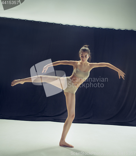 Image of Young teen dancer ion white floor background.