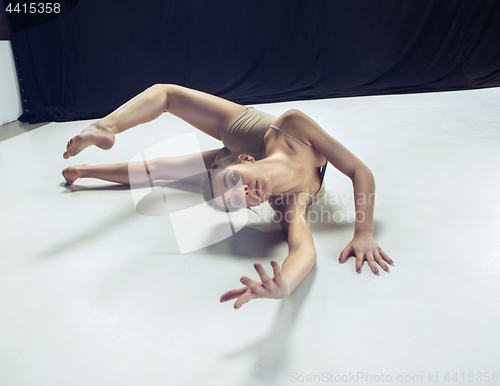 Image of Young teen dancer ion white floor background.