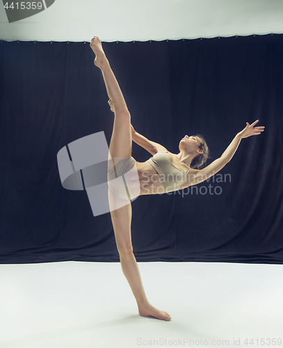 Image of Young teen dancer ion white floor background.