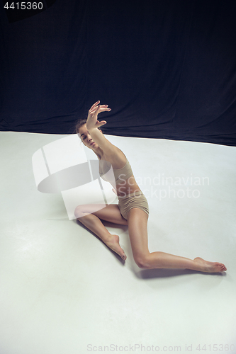 Image of Young teen dancer ion white floor background.