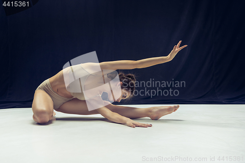 Image of Young teen dancer ion white floor background.