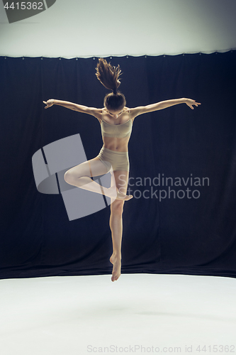 Image of Young teen dancer ion white floor background.