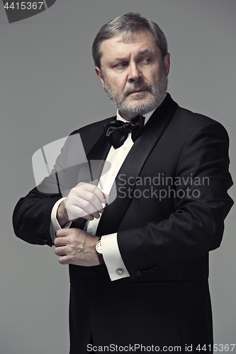 Image of Middle aged male adult wearing a suit isolated on gray