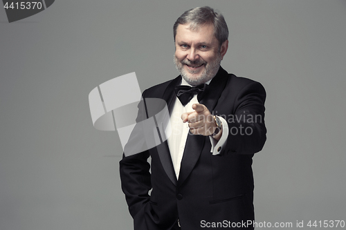Image of Senior Businessman standing and pointing to camera