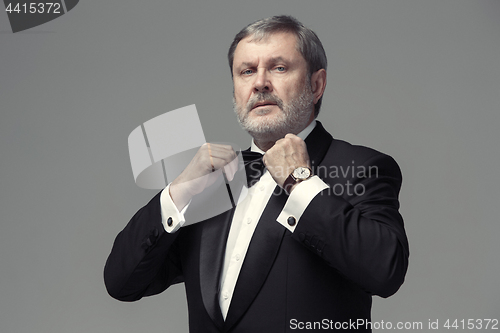 Image of Middle aged male adult wearing a suit isolated on gray