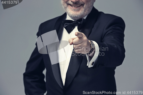 Image of Senior Businessman standing and pointing to camera
