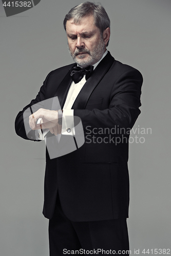 Image of Middle aged male adult wearing a suit isolated on gray