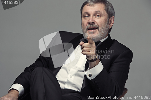 Image of Senior Businessman sitting in chair