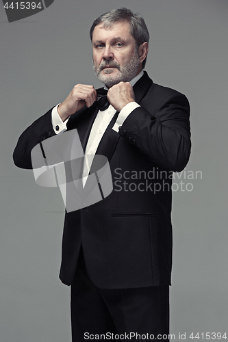 Image of Middle aged male adult wearing a suit isolated on gray