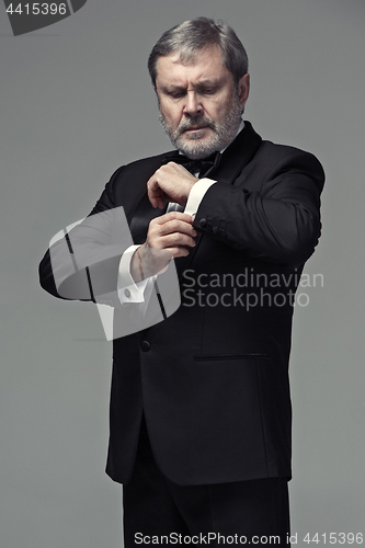 Image of Middle aged male adult wearing a suit isolated on gray