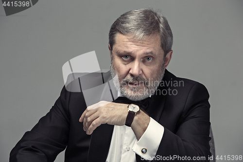 Image of Senior Businessman sitting in chair