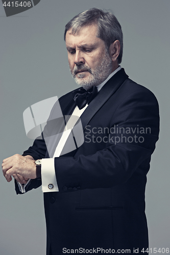 Image of Middle aged male adult wearing a suit isolated on gray