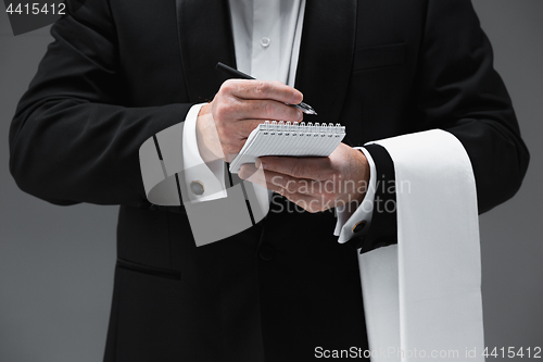 Image of Waiter taking an order wearing a waistcoat in a fancy restaurant