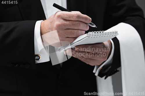 Image of Waiter taking an order wearing a waistcoat in a fancy restaurant