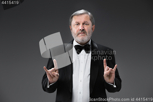 Image of Middle aged male adult wearing a suit isolated on gray