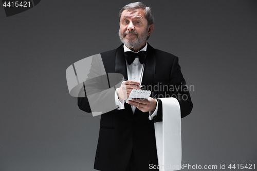 Image of Waiter taking an order wearing a waistcoat in a fancy restaurant