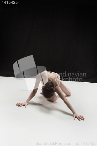 Image of Young teen dancer on white floor background.