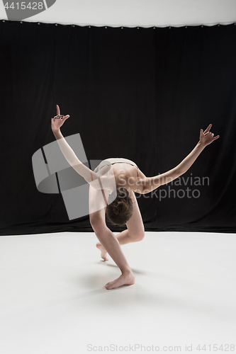Image of Young teen dancer on white floor background.