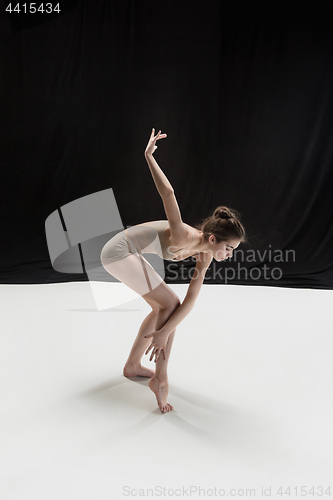 Image of Young teen dancer on white floor background.