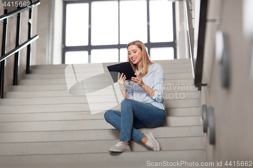 Image of woman or student with tablet pc sitting on stairs