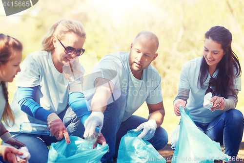 Image of volunteers with garbage bags cleaning park area