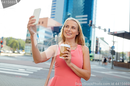 Image of woman with coffee taking selfie by smartphone