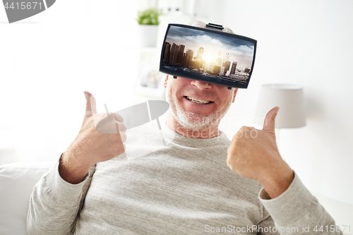 Image of old man in virtual reality headset shows thumbs up