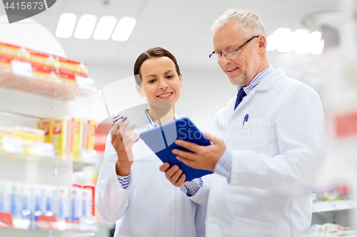 Image of apothecaries with tablet pc and drug at pharmacy