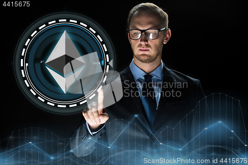 Image of businessman hand with ethereum hologram over black