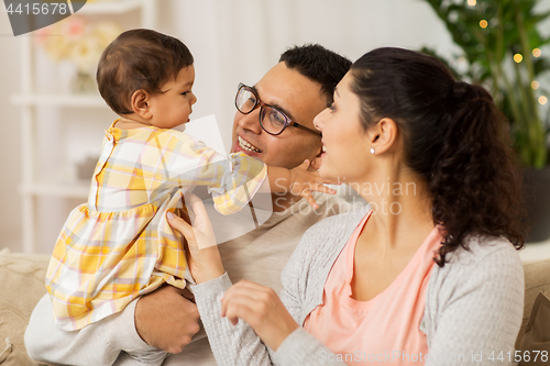 Image of happy family with baby daughter at home
