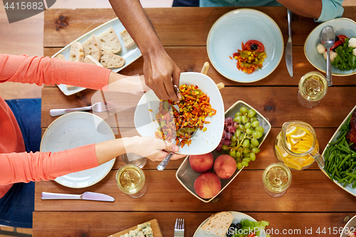 Image of people eating salad at table with food