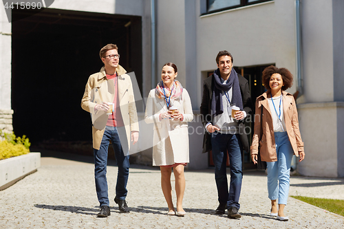 Image of office workers with coffee on city street