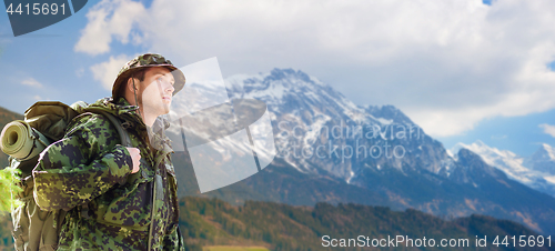 Image of soldier in military uniform with backpack hiking