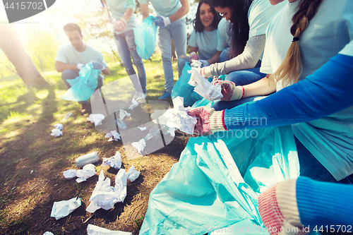 Image of volunteers with garbage bags cleaning park area