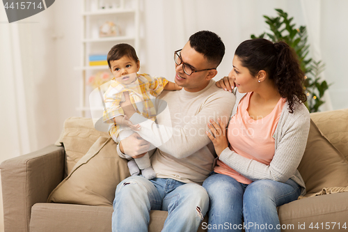 Image of happy family with baby daughter at home