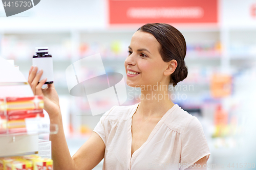 Image of female customer choosing drugs at pharmacy